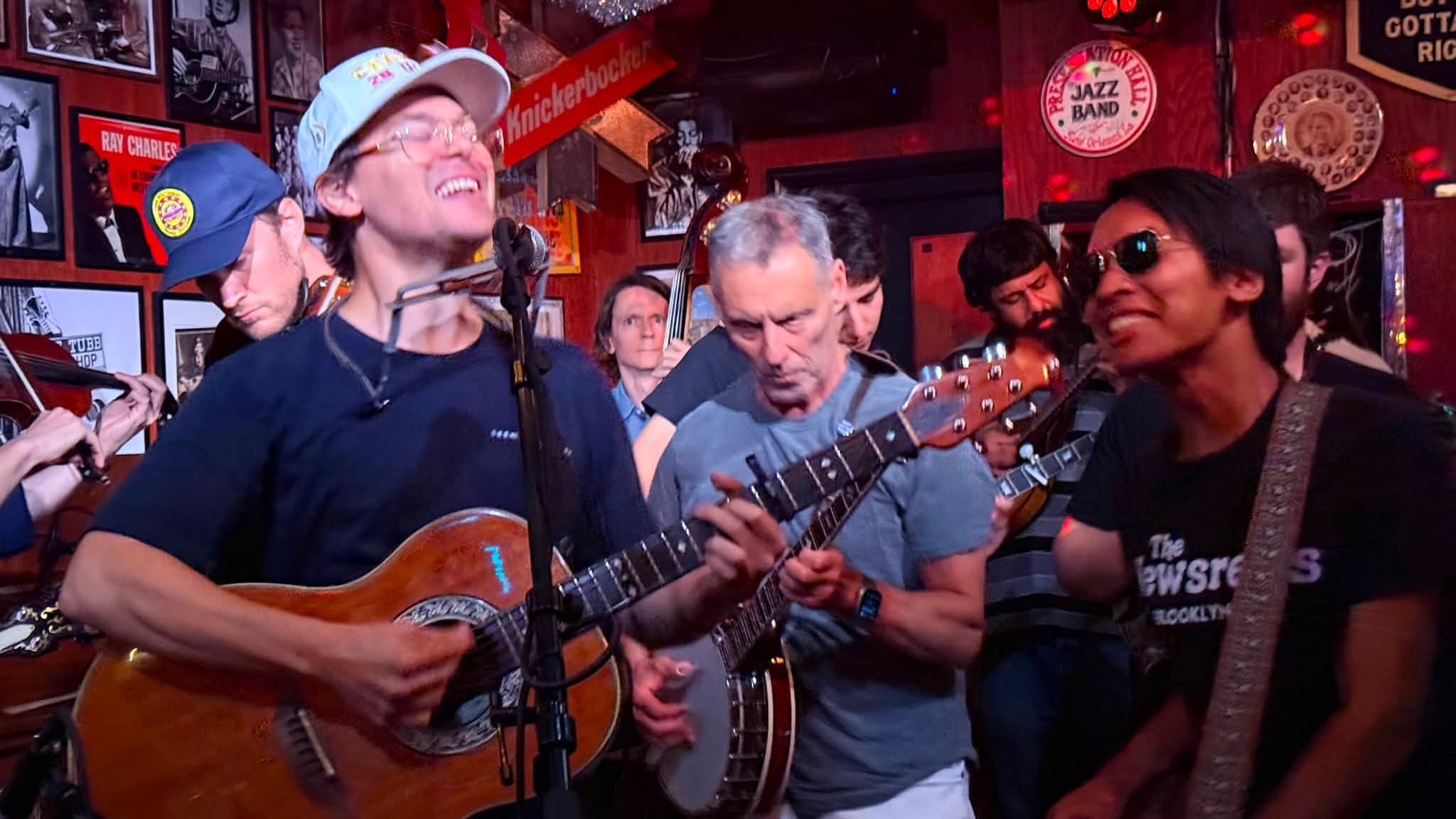 Andrew performing guitar and harmonica with other musicians
